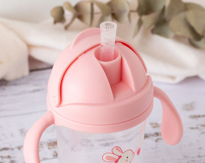 Taza de aprendizaje con asas Dino/Conejito  300 ml de Kiokids